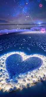 Heart-shaped design on a starry beach under a blue night sky.