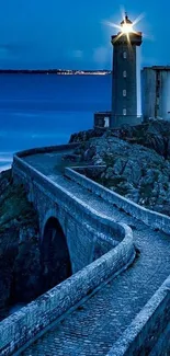 Scenic night view of lighthouse with cobbled path leading to the shore.