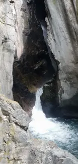 Rocky waterfall in a gorge with flowing water.