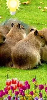 Capybara family sitting on lush grass with flowers and a lightbulb above.