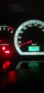 Illuminated car speedometer in night view, showcasing dashboard lights.