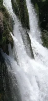 Cascading waterfall surrounded by lush greenery.