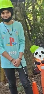 Person and panda statue with helmets in forest.