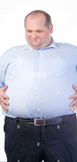 Man wearing a light blue shirt standing against a white background.