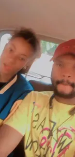 Two people in a car with blurred background, enjoying a casual moment.