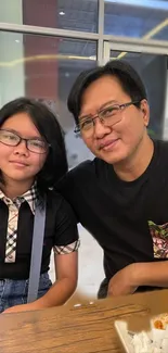 Family enjoying a meal in a casual dining setting, smiling and relaxed.