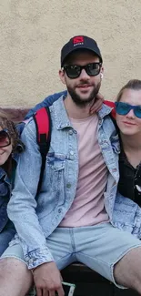 Happy family sitting on a bench outdoors, showcasing casual style.