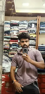 Mirror selfie with casual fashion in clothing store background.