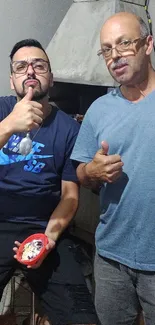 Two friends enjoying a casual gathering indoors with smiles.