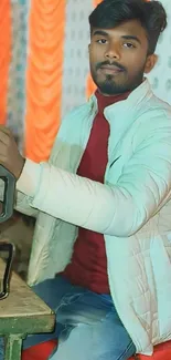 Young man in white jacket smiling indoors.