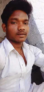 Young man in casual white shirt portrait with white and gray background.