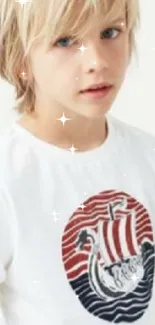 Young blonde boy in casual outfit with Nordic-themed shirt design.