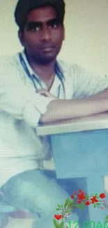 Man sitting at desk in a casual office setting.