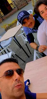 Group of friends at an outdoor café table.