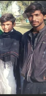 Outdoor portrait of two young people in casual attire.