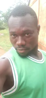 Outdoor portrait of a man in green tank top.