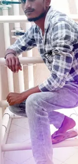 Casual portrait of a man outdoors wearing plaid shirt.