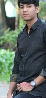 Casual portrait of a man outdoors with nature and trees in the background.