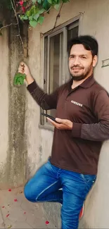 Person in casual attire posing outdoors with a smile.