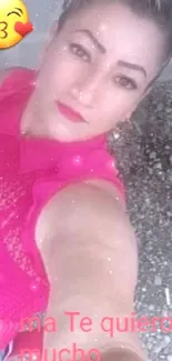 Woman in pink top taking a selfie.