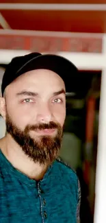 Portrait of a bearded man in a cozy, relaxed room setting.