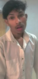 Casual portrait of a man in a white shirt.