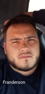 Portrait of a man sitting casually in a car seat.