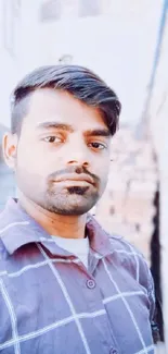 Casual portrait of a young man outdoors with a stylish, modern look.