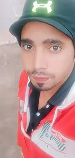 Person in a red jacket with a black cap, vibrant mobile wallpaper.