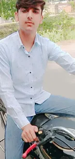 Young man on a motorcycle in a casual outfit.