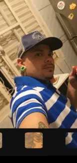 Casual selfie in blue striped shirt in a kitchen.