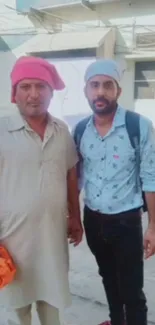 Two men in colorful headwear on street, casual style.