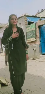 Woman in traditional attire on a rustic street.