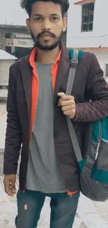 Young man in casual street style with a vibrant backpack.