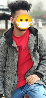 Stylish individual in grey jacket, red shirt, sitting on a bike in an urban setting.