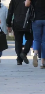 People walking on a busy street in casual attire.