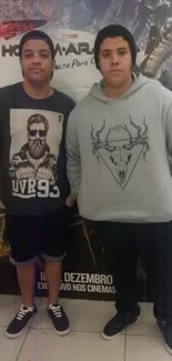 Two young individuals in trendy streetwear posing casually.