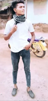 Young man standing with bike in rural area.