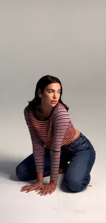 Casual fashion wallpaper with a woman in a striped top and jeans.