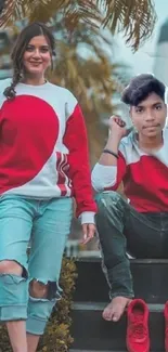 Trendy duo wearing red and denim in a fashionable pose.