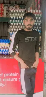 Young man poses outside an egg store.