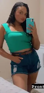 Mirror reflection with casual denim and green top outfit.