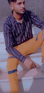 Man in orange pants and a striped shirt on stairs.