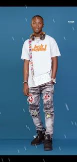 Trendy young man in casual attire on a blue background.