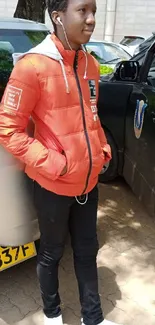 Person wearing orange jacket, urban street style.