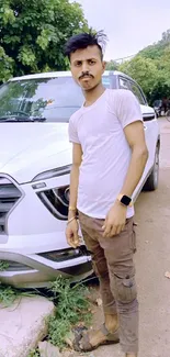 Young man in casual outfit beside car.