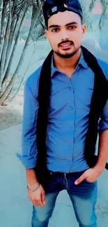 Young man in blue shirt standing stylishly with urban background.