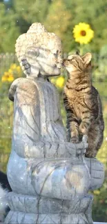 Cat interacting with Buddha statue in nature scene.