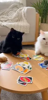 Cats playing a game of Uno on a small table.