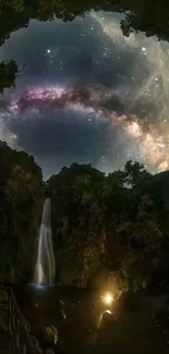 Starry sky viewed through a cave with a waterfall at night.